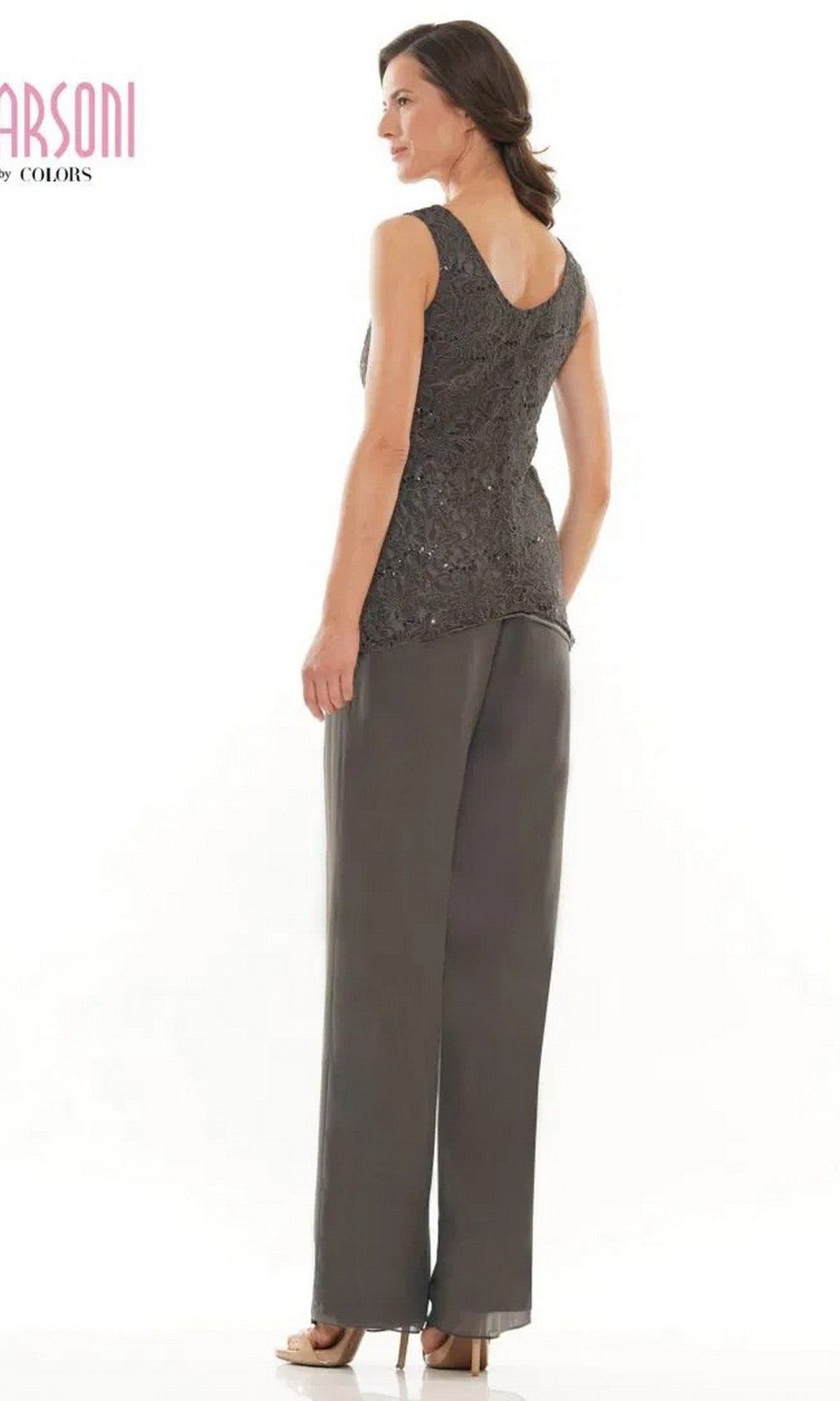 A woman stands facing away, wearing the sleeveless gray Marsoni M303 long formal pantsuit with high heels against a white background.